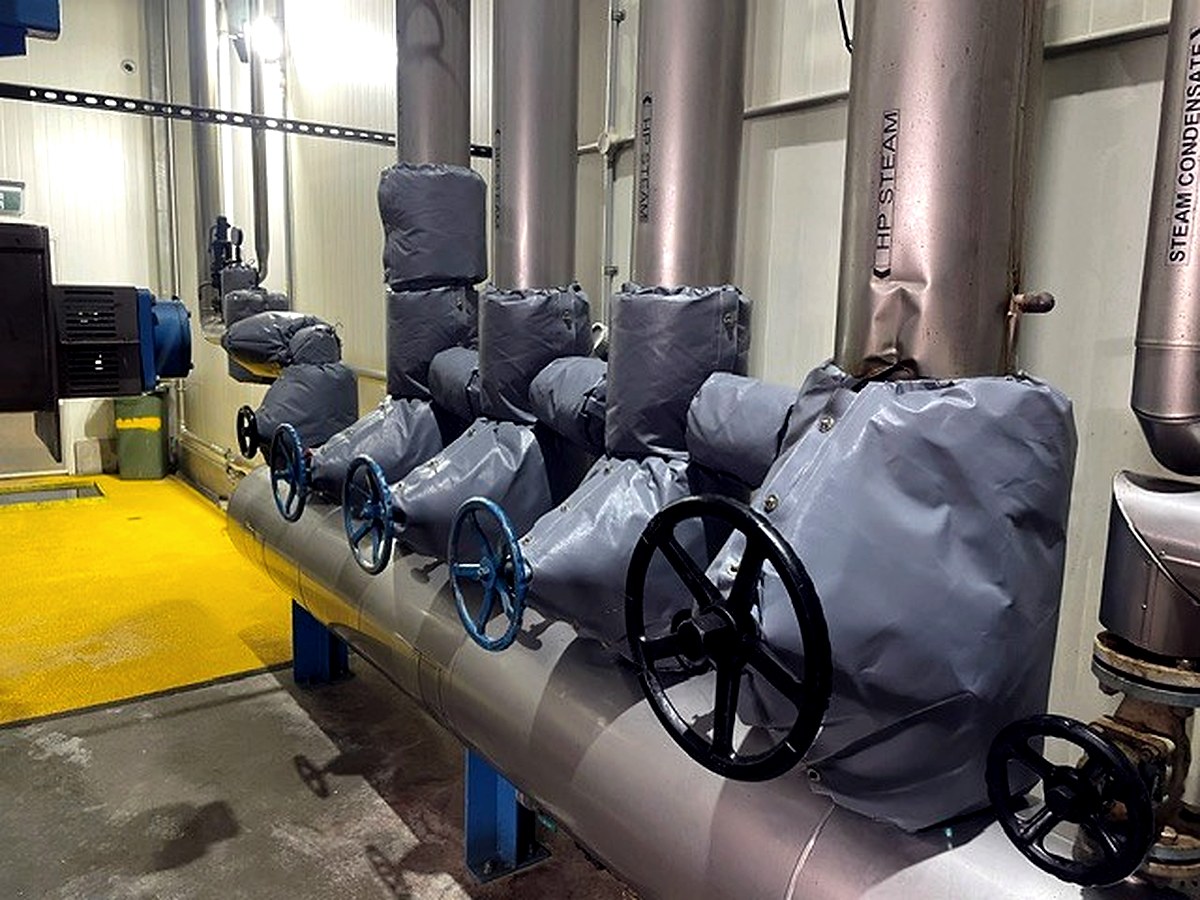 Thermal jackets on HP steam and steam condensate valve assemblies with labels visible